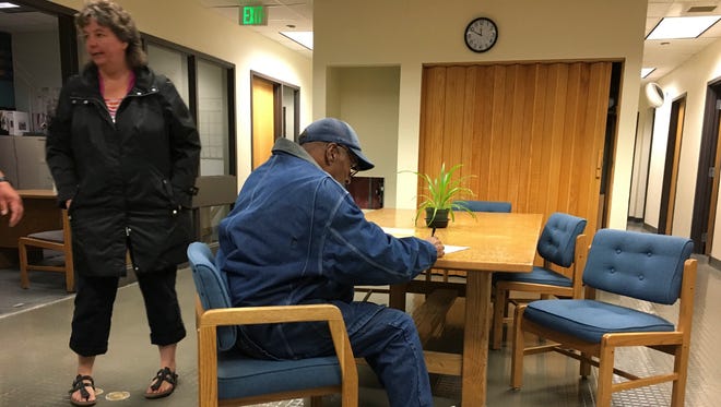 Former football legend O.J. Simpson signs documents at the Lovelock Correctional Center, Saturday, Sept. 30, 2017, in Lovelock, Nev. Simpson was released from the Lovelock Correctional Center in northern Nevada early Sunday, Oct. 1, 2017.