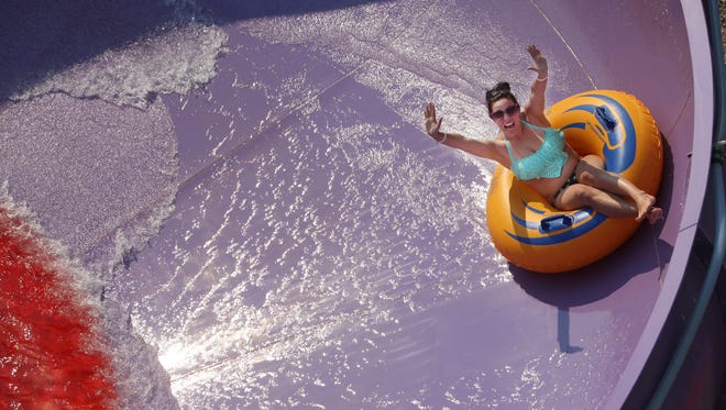 Kayla Kyle spins around 'Tornado Alley' at Wild Water West on Sunday, June 28, 2015. The new 55-foot tube slide attraction opened this season.