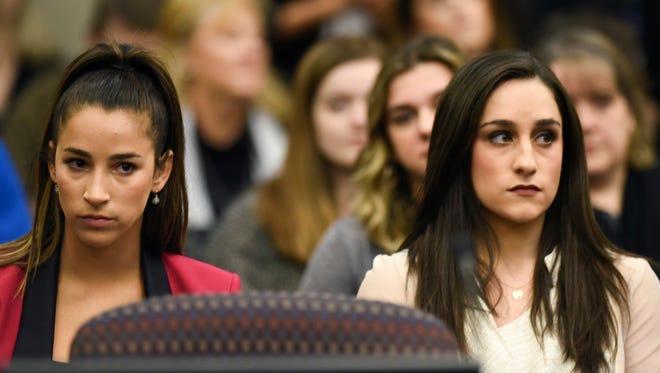 Former Olympians Aly Raisman, left, and Jordyn Wieber, right, sit on Jan. 19, 2018 during the fourth day of sentencing for former sports doctor Larry Nassar, who pled guilty to multiple counts of sexual assault.