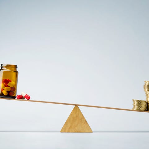 Coins and pills on a scale