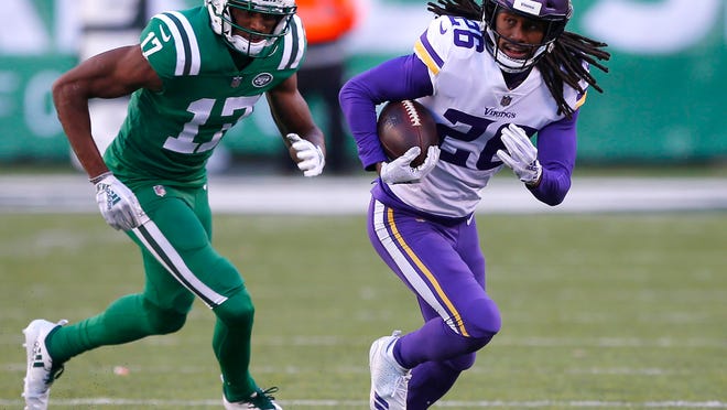 Oct 21, 2018; East Rutherford, NJ, USA; Minnesota Vikings cornerback Trae Waynes (26) runs from New York Jets wide receiver Charone Peake (17) after making an interception during the second half at MetLife Stadium. Mandatory Credit: Noah K. Murray-USA TODAY Sports