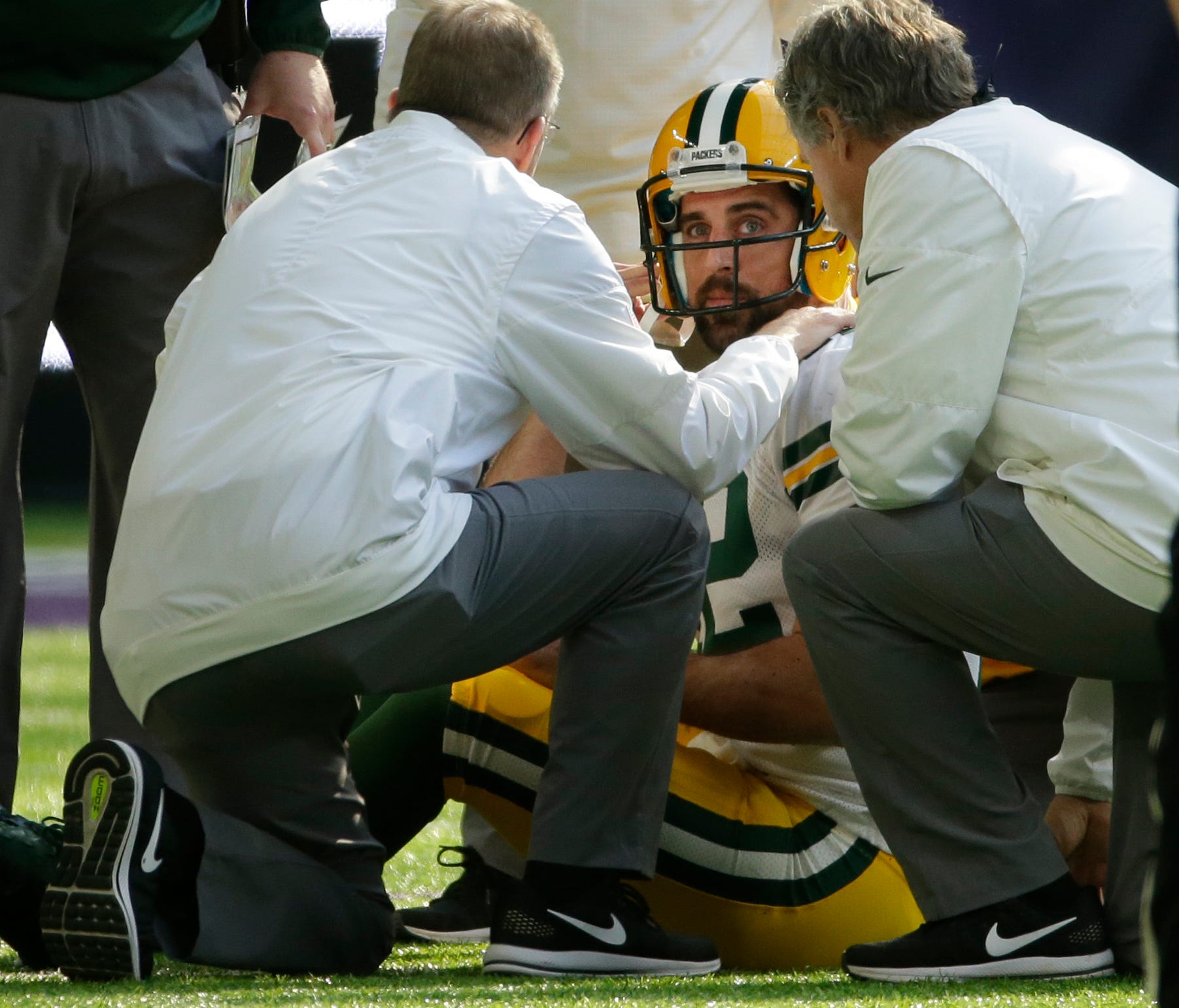 Green Bay Packers quarterback Aaron Rodgers (12) is tended to after being injured during the first quarter of their game against the Minnesota Vikings Sunday, October 5, 2017 at U.S. Bank Stadium in Minneapolis, Minn.