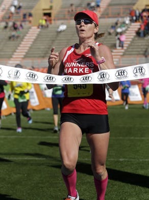 Ladies marathon winner, Gina Rouse, crosses the finish