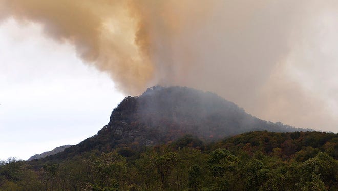 Crews work the Party Rock Fire near Lake Lure Friday afternoon, Nov. 11, 2016. A forest fire has crossed its containment line, forcing more evacuations in western North Carolina. State and federal fire officials say portions of Chimney Rock and Lake Lure communities are now under evacuation orders due to the Party Rock Fire. (Patrick Sullivan  /The Times-News via AP)