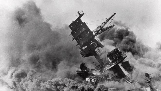 In this Dec. 7, 1941 file photo, smoke rises from the battleship USS Arizona as it sinks during a Japanese surprise attack on Pearl Harbor, Hawaii.