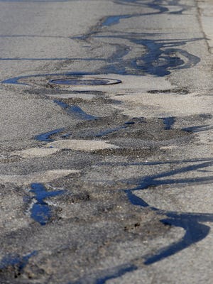 A long stretch of potholes and patches on M-43/Saginaw Highway in Lansing.