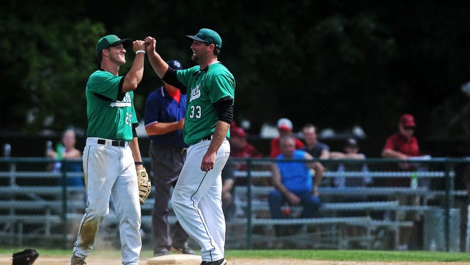 Renner Monarchs' Dave Borchardt, left, (25) and Jack VanLeur (33) react after defeating the Vermillion Red Sox in the State Amateur Baseball Tournament class A Championship game on Sunday, Aug. 17, 2014, at Cadwell Park in Mitchell, S.D.