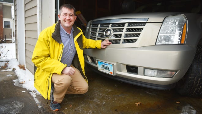Matt Parker shows off his vanity license plate Tuesday, Jan. 30, at his home in Sioux Falls. Matt's says "JHAWK" and his wife Kate's license plate says "KATYDID."