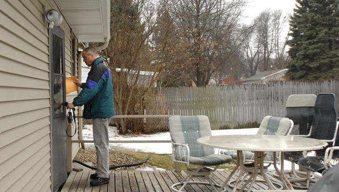 A code enforcement officer delivers a citation to a residence that has violated a building code in South Dakota. Stevens Point may create a similar position to increase code compliance in the city.