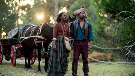 This image released by Entertainment One/BET shows Aunjanue Ellis, left, and Cuba Gooding Jr. in a scene from "The Book of Negros," a six-part miniseries starting Monday at 7 p.m.