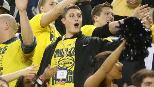 Zach Gentry, center, took in a basketball game when he visited Michigan.