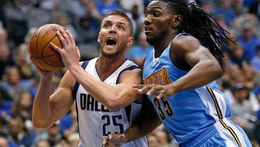 Dallas Mavericks forward Chandler Parsons (25) drives inside next to Denver Nuggets forward Kenneth Faried (35) during the second half of an NBA basketball game Friday, Feb. 26, 2016, in Dallas. (AP Photo/Ron Jenkins)