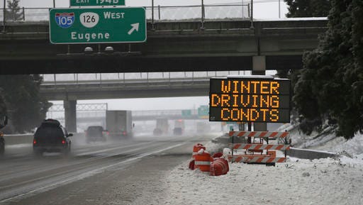 Traffic moves slowly along Interstate 5 through Eugene and Springfield, Ore. area as a winter storm moves through the Willamette Valley Sunday Jan. 8, 2017. Snow and sleet are making for treacherous roads in Oregon, with the state police warning that they can't keep up with all the crashes. (Chris Pietsch/The Register-Guard via AP)