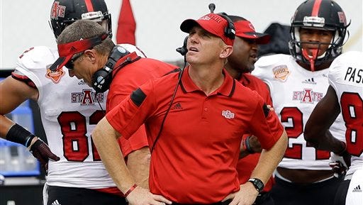 Arkansas State head coach Blake Anderson looks at a replay in the first half of an NCAA college football game against Miami in Miami Gardens, Fla., Saturday, Sept. 13, 2014. (AP Photo/Alan Diaz)
