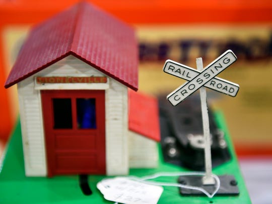A station house with a railroad crossing sign is shown