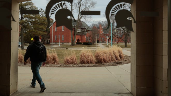 Spartan logos are seen on a window from a parking garage on the Michigan State University campus in East Lansing in this March 2015 file photo.