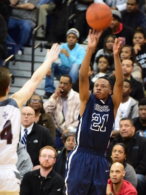 Thurston senior Marquie'l Thomas launches a three-point shot during Monday's game against U of D Jesuit.