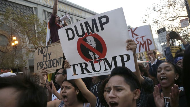 Protesters gather Wednesday in San Francisco to express opposition to Donald Trump's presidential election victory.
Protesters yell in opposition of Donald Trump's presidential election victory.