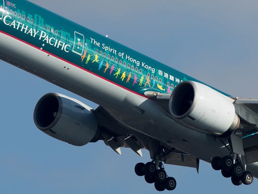 A colorfully embellished Cathay Pacific Boeing 777 jet