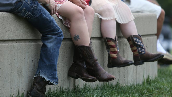 Cowboy boots are standard attire on the first day of the Buckle Up Music Festival.