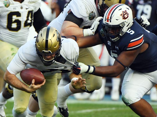 If the Lions don't spend the No. 3 pick on Auburn defensive tackle Derrick Brown, shown here sacking then-Purdue QB David Blough in the 2018 Music Bowl, they'll need to address the interior of their defensive line somewhere in the draft.