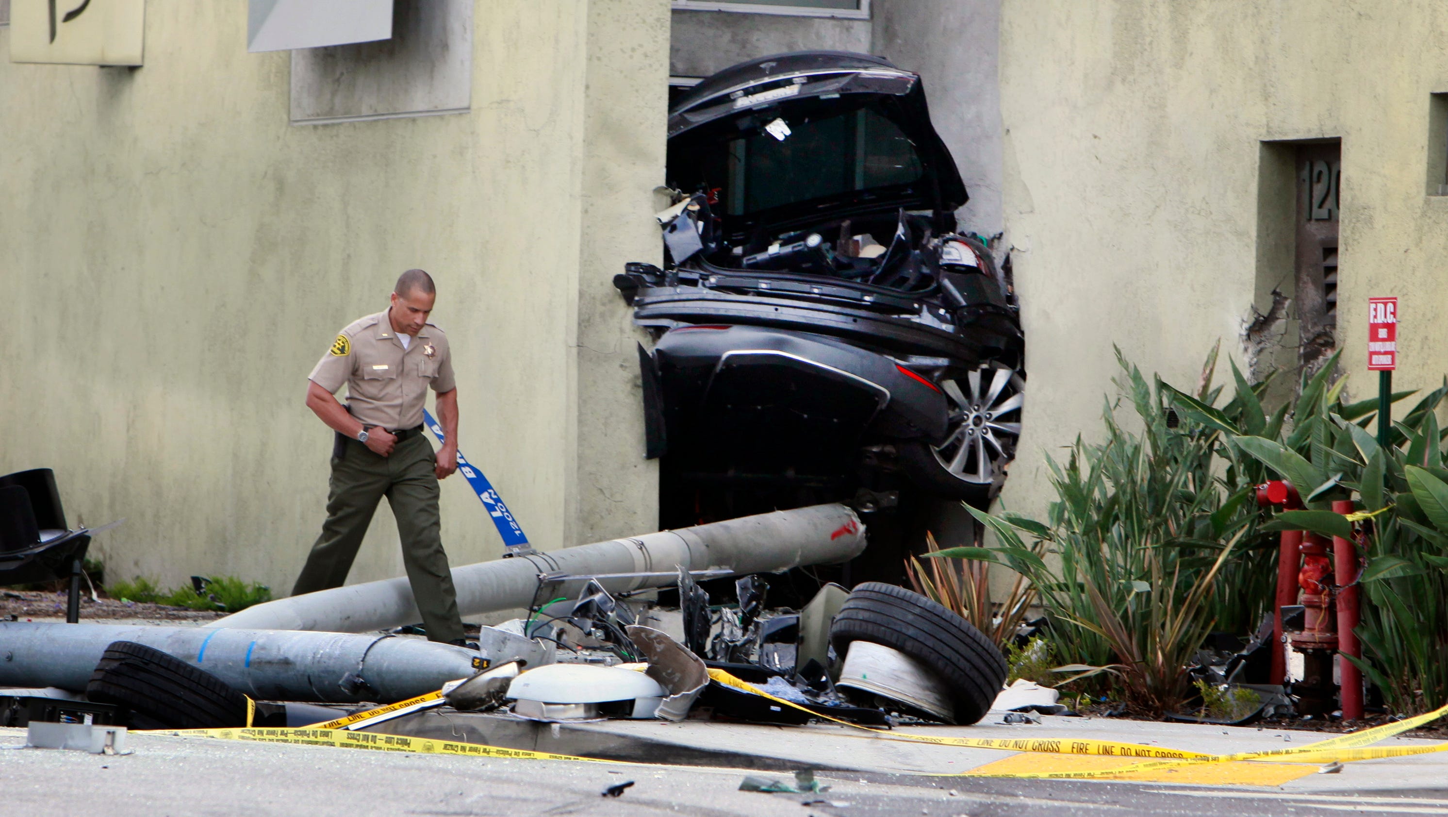 Tesla splits in half after police chase, crash