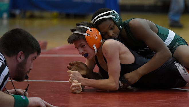 Groves freshman Damon Dunbar wrestles Brother Rice's Anthony Dangelo in Wednesday's D-1 district semifinal