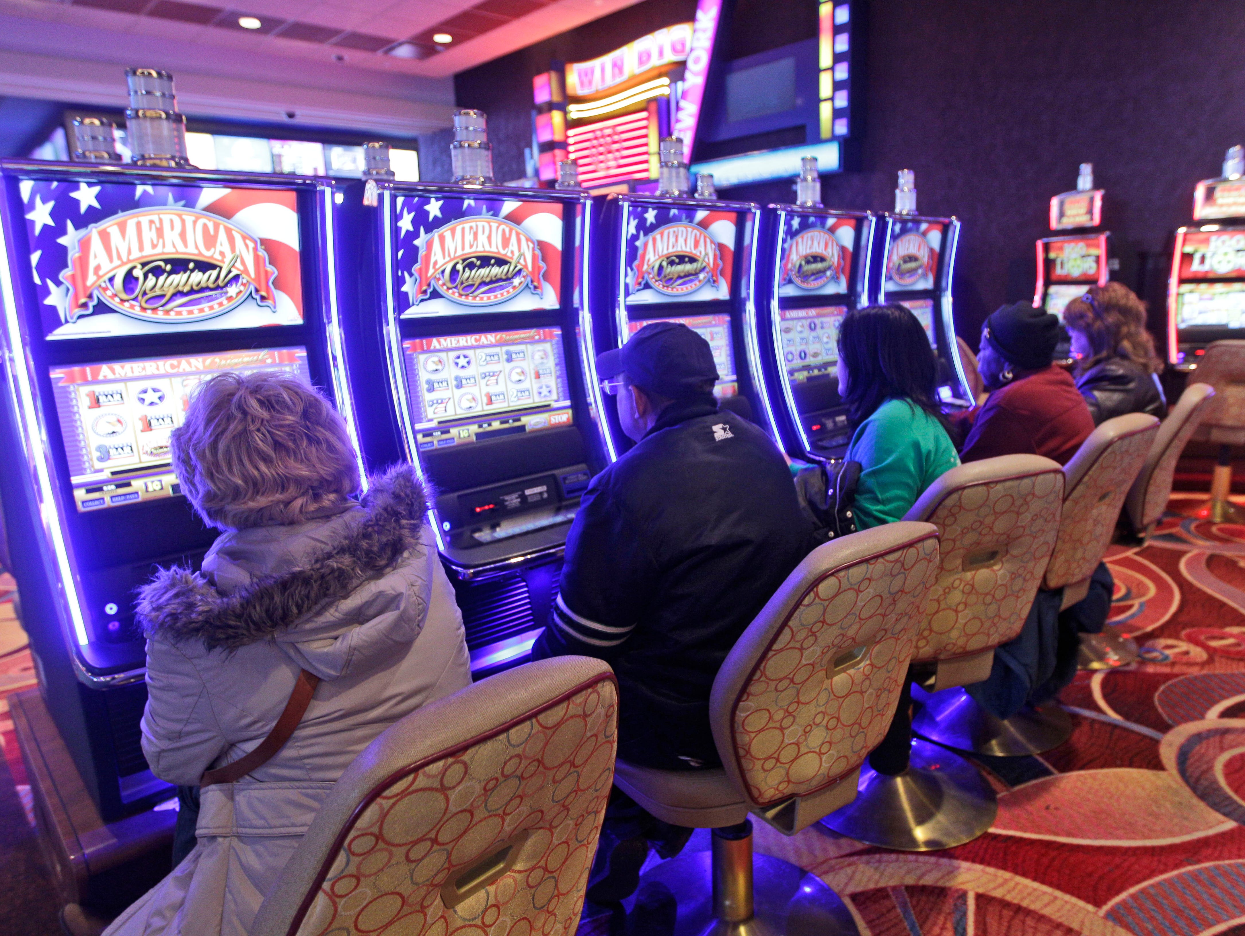 Gamblers play the slot machine machines at the Resorts World Casino,  Jan. 4, 2012, in the Queens borough of New York City.