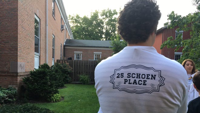 Shirts are given outside a Village Board meeting Aug. 15, 2017, to those supporting development on Schoen Place.
