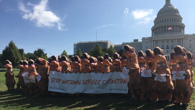 Protesters dressed as dinosaurs gathered on the Capitol lawn on Aug. 30, 2017, to demonstrate against Trump's budget cuts.