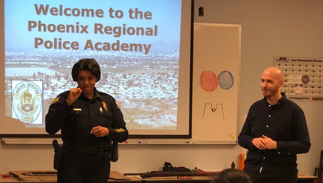 Phoenix Police Chief Jeri Williams speaks at an educational outreach even for residents who are deaf and hard of hearing on March 24, 2018, as Dustin McLaws, licensed sign-language interpreter, looks on. The event aimed to bridge communication barriers and establish a better sense of understanding between law enforcement and the deaf community.
