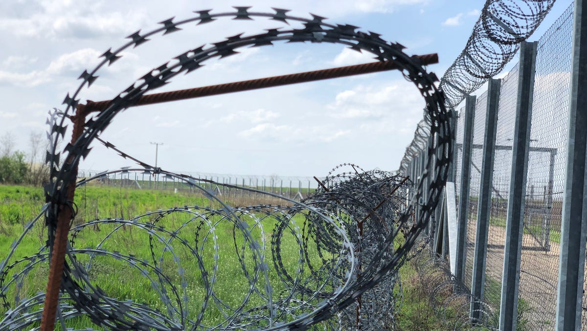 Barbed wire is seen near the end of border fence in Hungary near the country's international boundary with Serbia and Romania, on April 13, 2018.