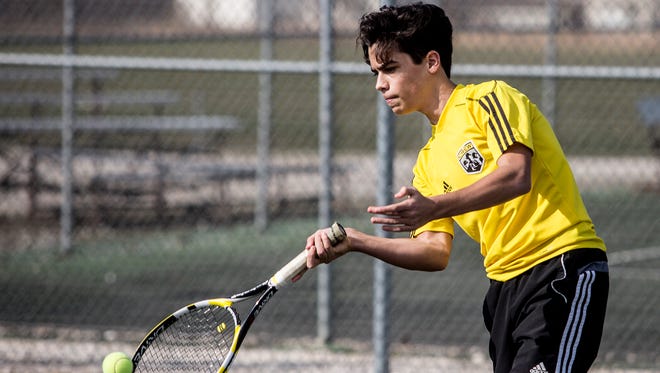 Sergio Santalla practices with his tennis team Friday afternoon. 