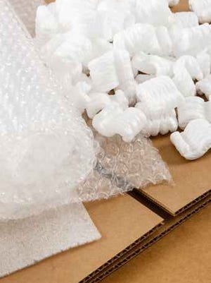 Bubble wrap in a shipping carton with Styrofoam peanuts.