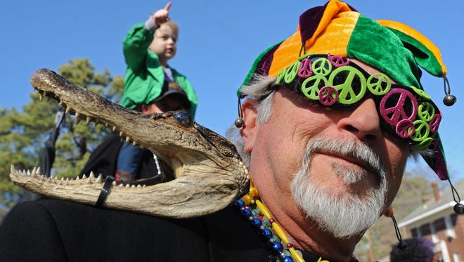 Mike Silva wears his Alligator jacket at the 2016 Krewe of Highland parade.