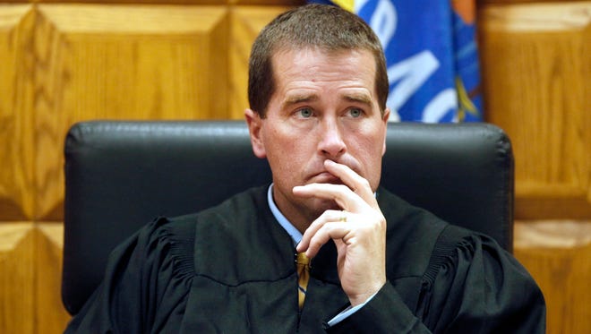 Judge Mark McGinnis listens during a 2013 preliminary hearing at the Outagamie County Justice Center in Appleton.
