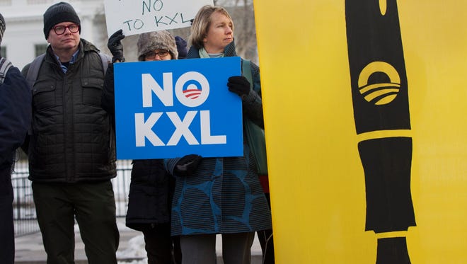 People demonstrate against the Keystone XL pipeline outside the White House in Washington, D.C., on Tuesday