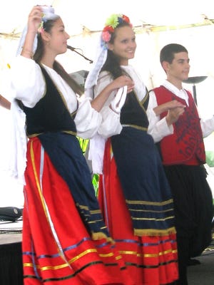 Three dancers of the Holy Spirit Youth Dancers perform at the 2014 Greek Fest.