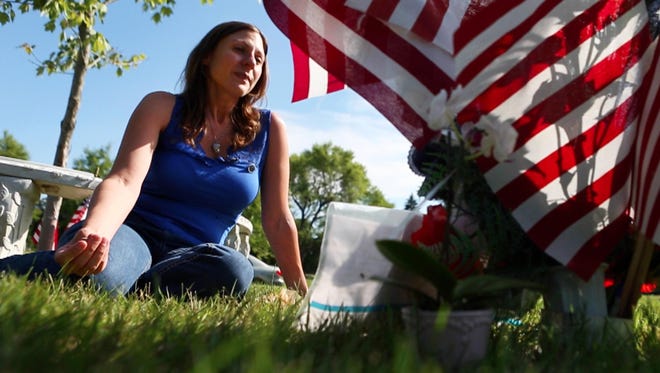 Amy Pierson sits at Daryl's Pierson's grave following the sentencing of Thomas Johnson III in White Haven Memorial Park on July 16, 2015.