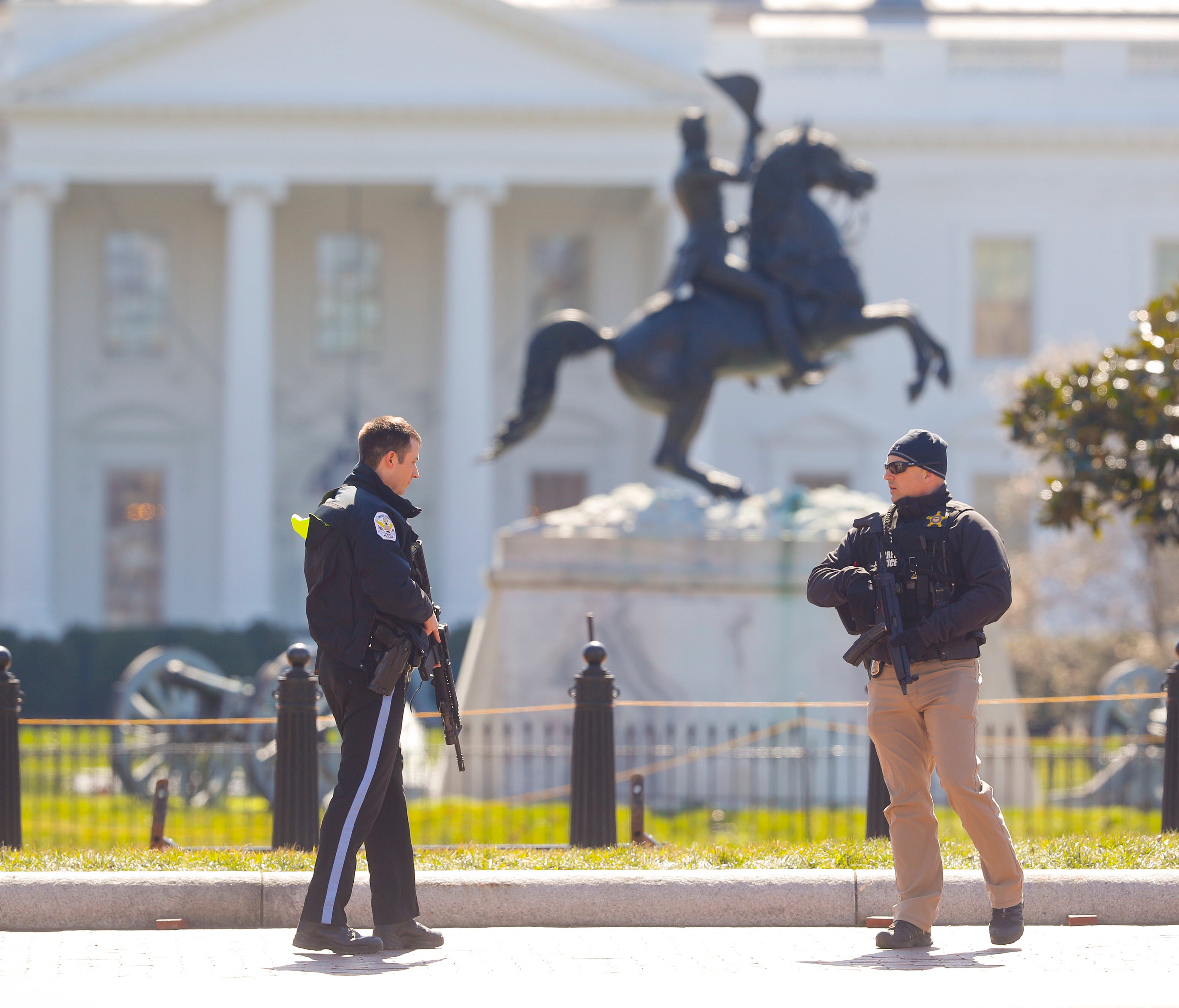 Law enforcement officers at Lafayette Park across from the White House in Washington, close the area to pedestrian traffic, Saturday, March 3, 2018. A man apparently shot himself along the north fence of the White House midday, according to the Secre
