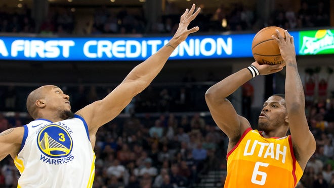 Utah Jazz guard Joe Johnson (6) shoots the ball against Golden State Warriors forward David West (3) during the second half at Vivint Smart Home Arena.
