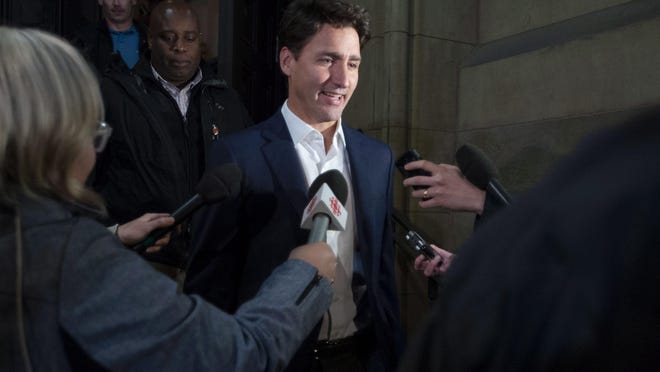Prime Minister Justin Trudeau leaves the Office of the Prime Minister and Privy Council after an agreement was reached in the NAFTA negotiations in Ottawa, Ontario, Sunday, Sept. 30, 2018. The U.S. and Canada reached the basis of a free trade deal Sunday night, a senior Canadian government official said. (Justin Tang/The Canadian Press via AP)