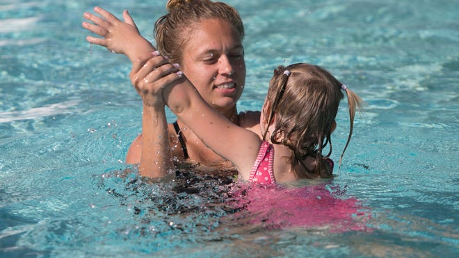 Instructor Lindsay Kiszczak works with 3-year-old Diana Ciezki during swimming lessons this past week at the Sunrise Pool in Peoria.