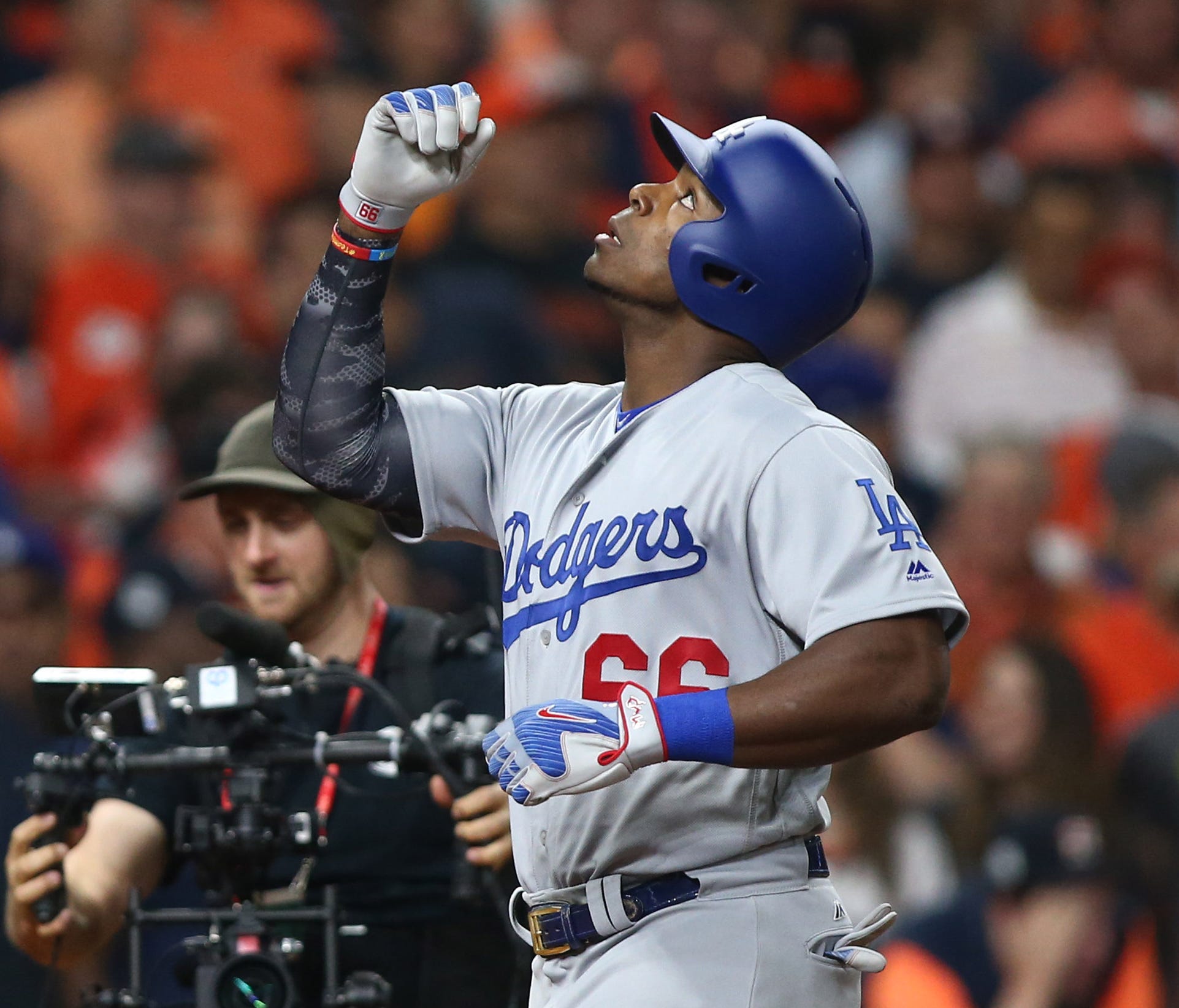 Yasiel Puig points to the sky after hitting a two-run home run in the ninth inning.