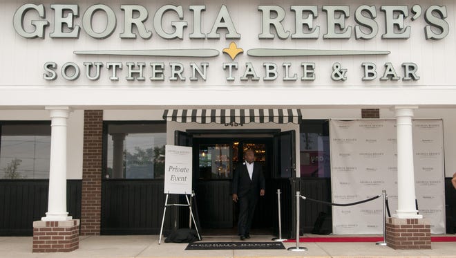 Owner and former Indianapolis Colts linebacker Gary Brackett walks through the doors of Georgia Reese's Southern Table & Bar at 86th and Michigan streets for a private debut on Aug. 30, 2014. The restaurant opened to the public on Sept. 2, 2014.