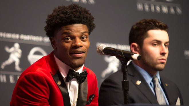 Louisville quarterback Lamar Jackson, left, makes a point during a press conference prior to the Heisman Trophy announcement. Jackson is the favorite to win the award. Dec. 10, 2016