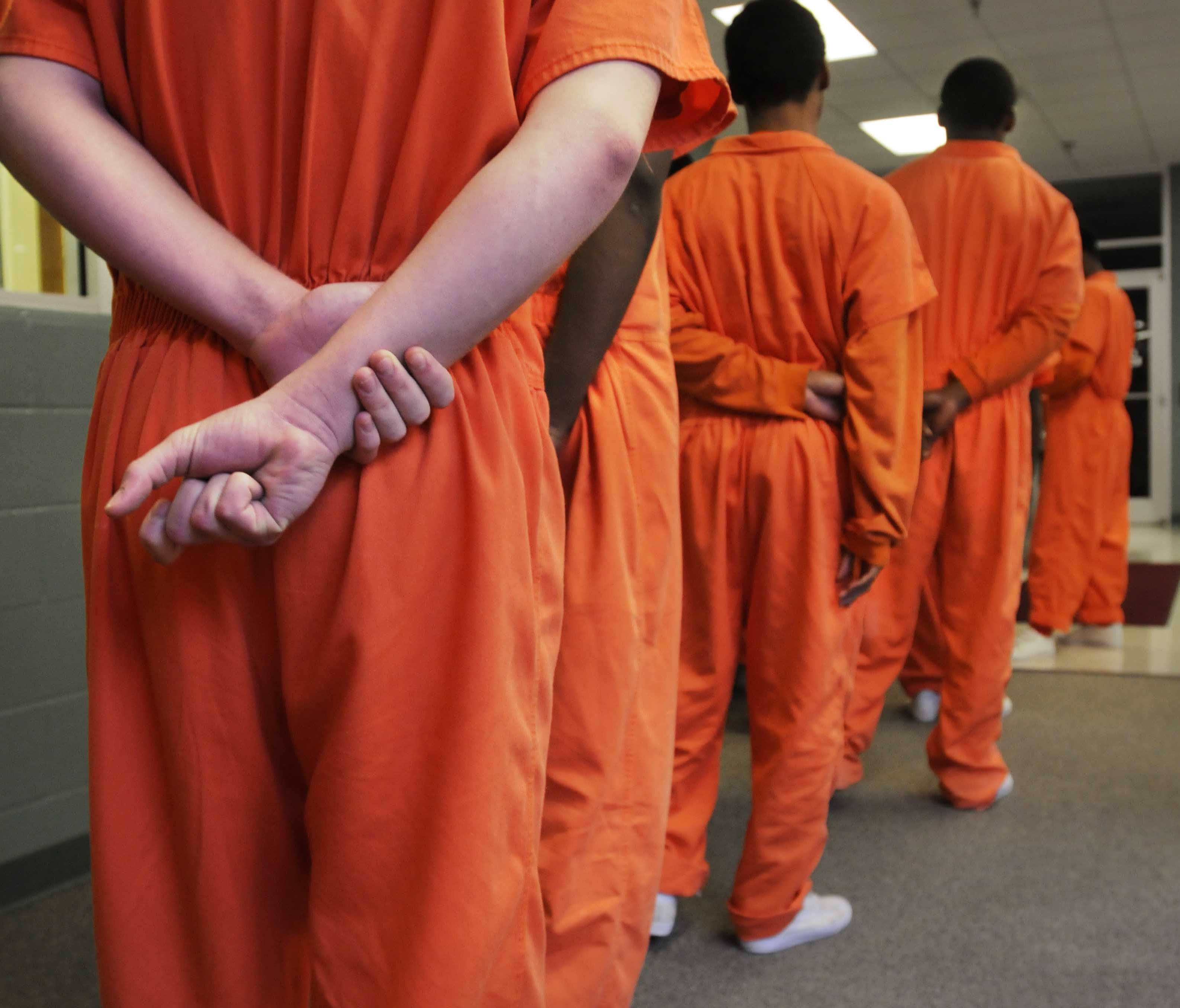 Residents stand in line for breakfast recently at a juvenile detention center.