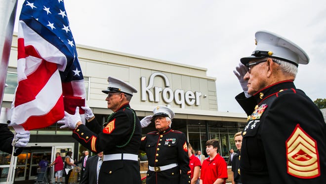 November 2, 2016 - Al DeWitt, (left) raises the American flag with fellow Marine Corps League member Phillip Taylor as comrades James G. Kern and Jim Brown salute during the grand-opening ceremony of the Midtown Kroger on Wednesday morning.