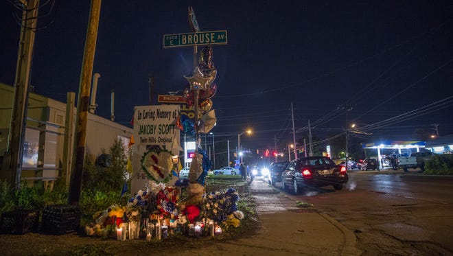 Four people were wounded in a northside shooting Thursday night near this homicide vigil at the corner of 34th Street and Brouse Avenue.