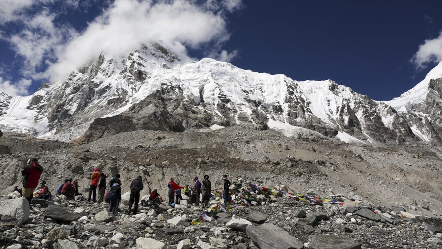 Mount Everest peeks through the clouds in this Sept.